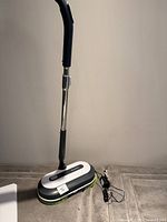 Full view of mop with handle extended and charger cord