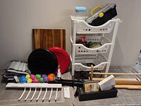 Group shot of entire lot showing storage tower, toolbox, container, cutting board, balance discs and additional items