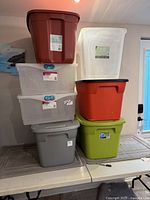 Full stack of seven storage totes on table