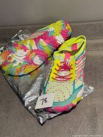 Top view of both shoes showing colourful rubber soles and mesh uppers