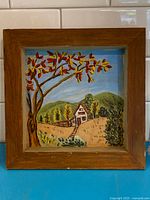 Overall view of framed folk art painting showing scene and frame