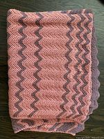 Folded crochet blanket showing chevron pattern