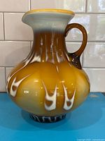 Full view of art glass pitcher showing shape, handle, color gradient, and pattern
