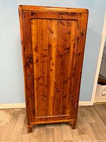 Front view of cedar chifforobe showing door, feet and hardware