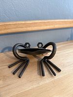 Front view of welded steel frog showing hex-nut eyes and rod legs