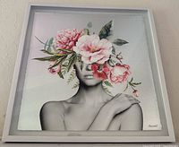 Full view of framed canvas artwork showing portrait with floral overlay