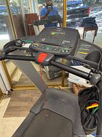 Front view of Precor 9.33 treadmill showing console, handrails, belt, safety key
