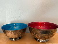 Front view of both bowls showing colored interiors and tarnished exteriors