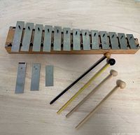 Top view of xylophone, three spare bars, four mallets