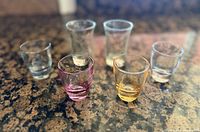 All six shot glasses, front and rear rows, showing colours and shapes