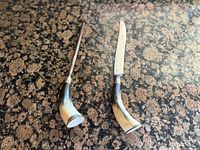 Carving knife and honing steel showing handles and overall shape