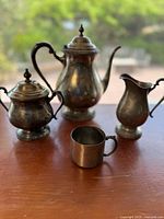 Front view of all four silver-plated pieces