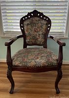 Front view showing carved frame and floral upholstery