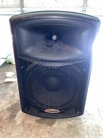 Front view of Harbinger APS15 speaker showing grille and logo