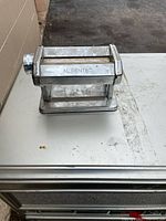 Front view showing Al Dente branding and rollers