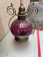 Full view of mosaic glass lantern showing pattern and metal hardware