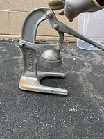 Side view showing Artimetal branding, lever mechanism and cup