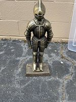 Front view of cast iron knight statue on base