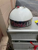 Side view showing Coors logo on chrome band