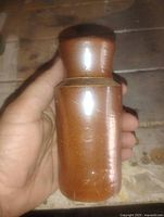 Front view of brown glazed stoneware bottle crock