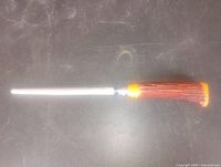 Full view of sharpening steel showing metal rod and ribbed Bakelite handle