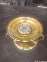 Top angled view of brass teapot heater showing mesh burner insert and side support arms