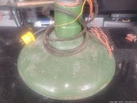 Green enamel metal ceiling light with wiring coiled on top