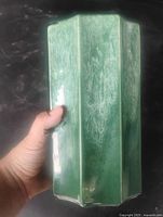 Side view showing fluted green ceramic vase