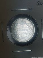 Reverse of 1898 5-cent coin showing crown, wreath and date