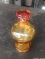 Full view of amber glass perfume bottle with stopper