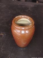 Front view of brown glazed stoneware crock