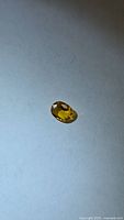 Golden yellow oval-cut sapphire front view