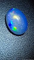 Oval cabochon opal showing body clarity and play of color