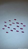 Group of marquise-cut rubies on white background