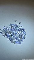 Pile of loose marquise-cut tanzanites