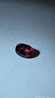 Ruby gemstone on flat surface showing color and cut