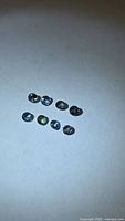 Eight small round sapphires on white background