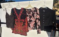 front view of all five tops hanging