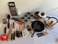Overview of entire lot showing cookware, utensils, and bakeware grouped together