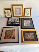 All seven framed prints laid out for overview