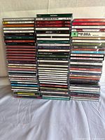 Front view of five stacked columns of CDs showing artist spine text