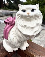 Front three-quarter view of Betlar white Persian cat figurine showing bow and facial details