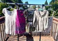 All five INC tops hung on rack