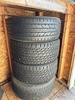 Stack of four tires showing tread depth and overall condition