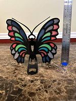 Front view of butterfly tealight holder with ruler indicating height