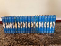 20 blue hardcovers lined side-by-side
