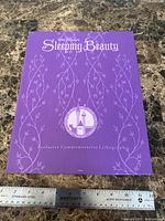 Front of purple presentation folder titled Sleeping Beauty