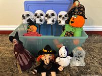 Group view of skull stakes, plush figures, tombstone, jack-o-lantern and storage bin