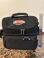 Front view of cooler bag with Harley-Davidson logo and ruler for scale