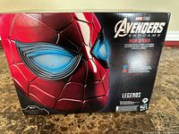 Front of retail box showing Iron Spider helmet graphic